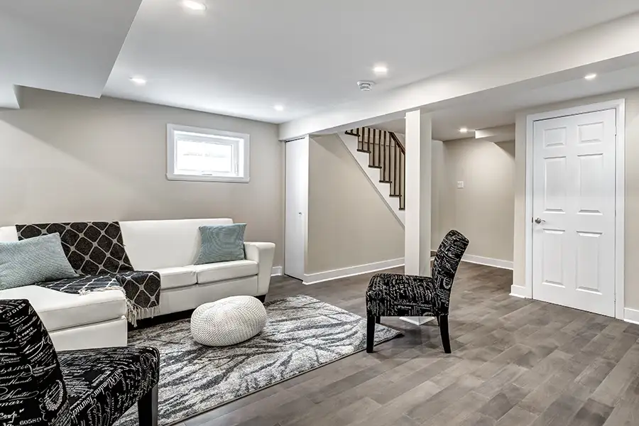 finished basement with couch and chairs