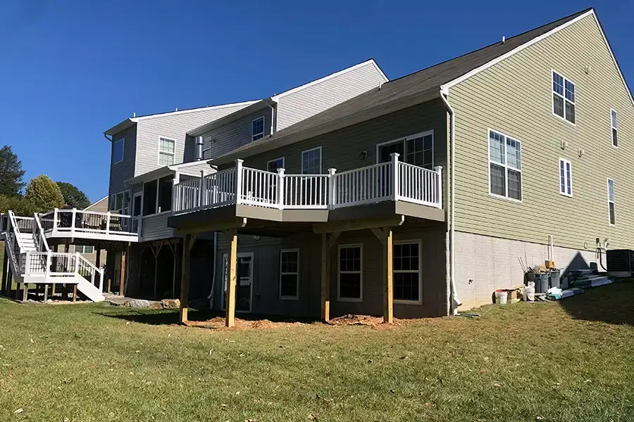 back of home with raised deck being constructed